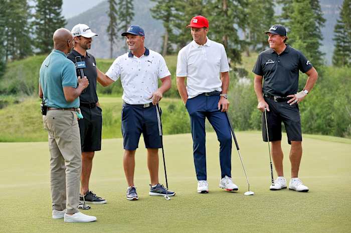 Aaron Rodgers, Bryson Dechambeau, Tom Brady and Phil Mickelson stand to be interviewed at their golf match.